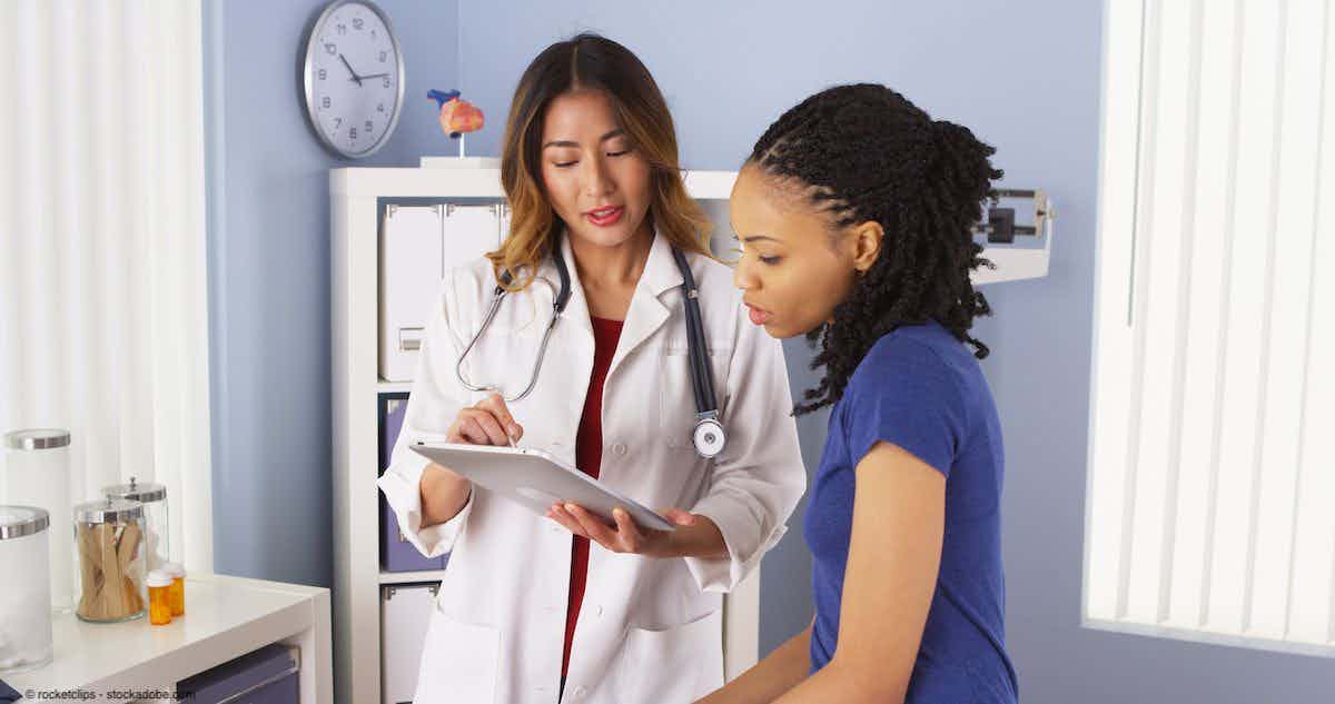 African American patient explaining issues to Asian doctor using tablet | Image Credit: © rocketclips - stockadobe.com