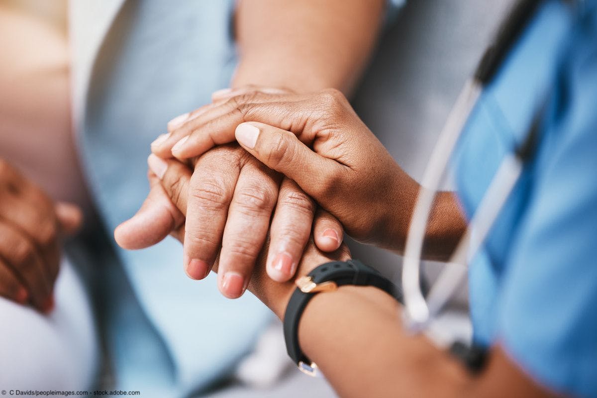 hands of a doctor holding a patient's hand
