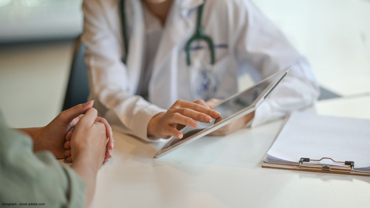 doctor showing patient information on a tablet