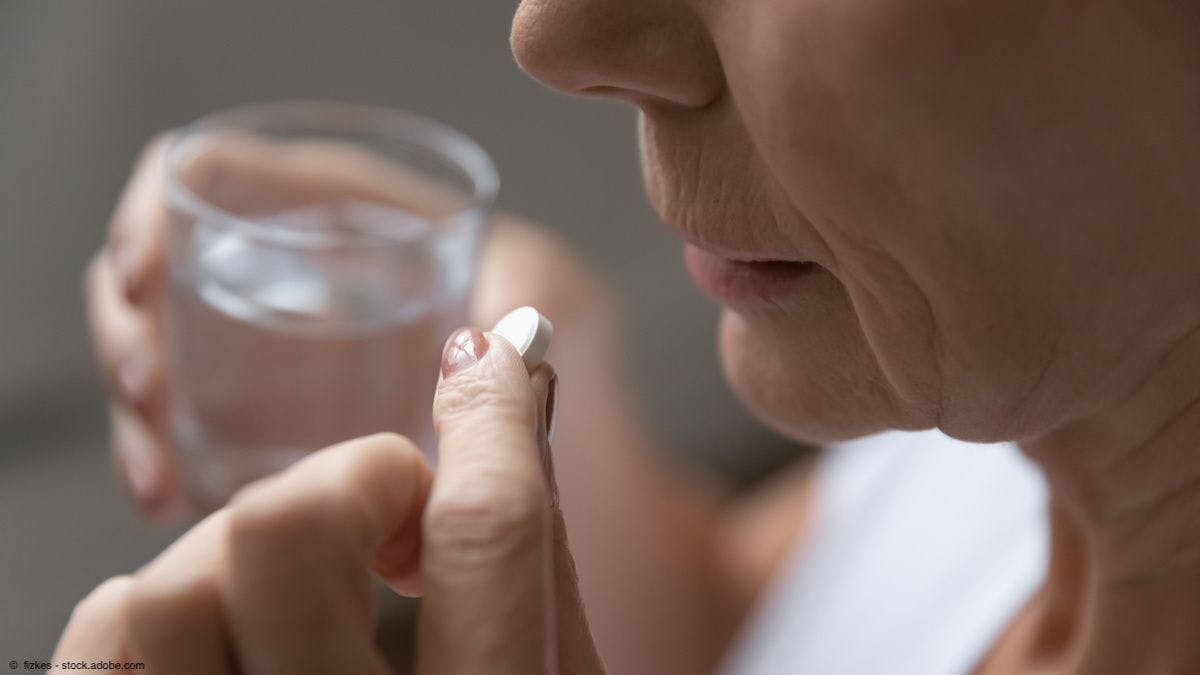 Close-up of elderly woman about to take aspirin | Image Credit: ©  fizkes - stock.adobe.com