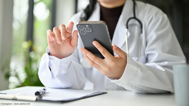 female doctor typing on cellphone