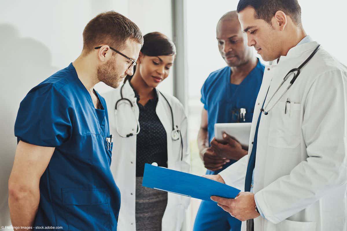 Group of doctors reading a document | Image Credit: © Flamingo Images - stock.adobe.com
