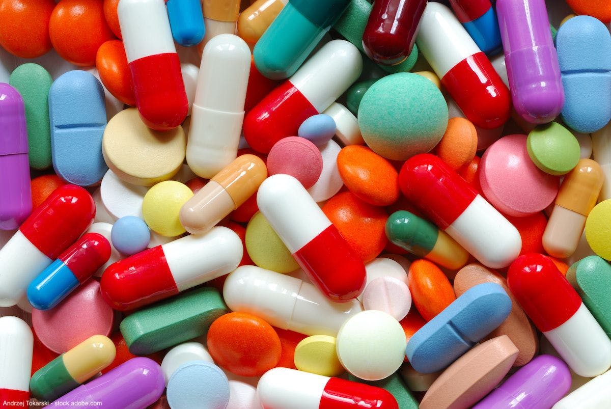 large assortment of loose pills and capsules of different colors